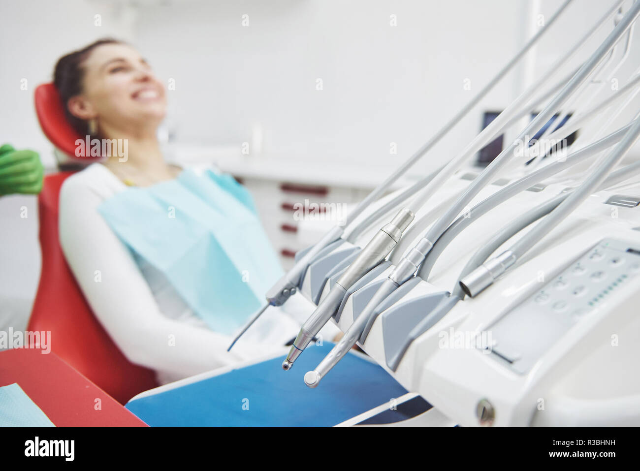 Young female patient sitting on chair in dental office.preparing for dental exam Stock Photo