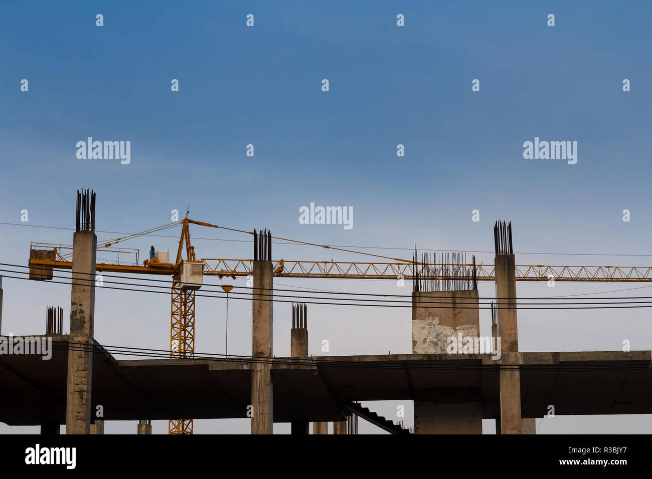 Lifting crane and building in construction site Stock Photo