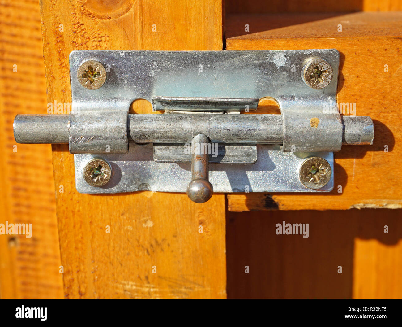 Metal lock on a wooden door Stock Photo - Alamy