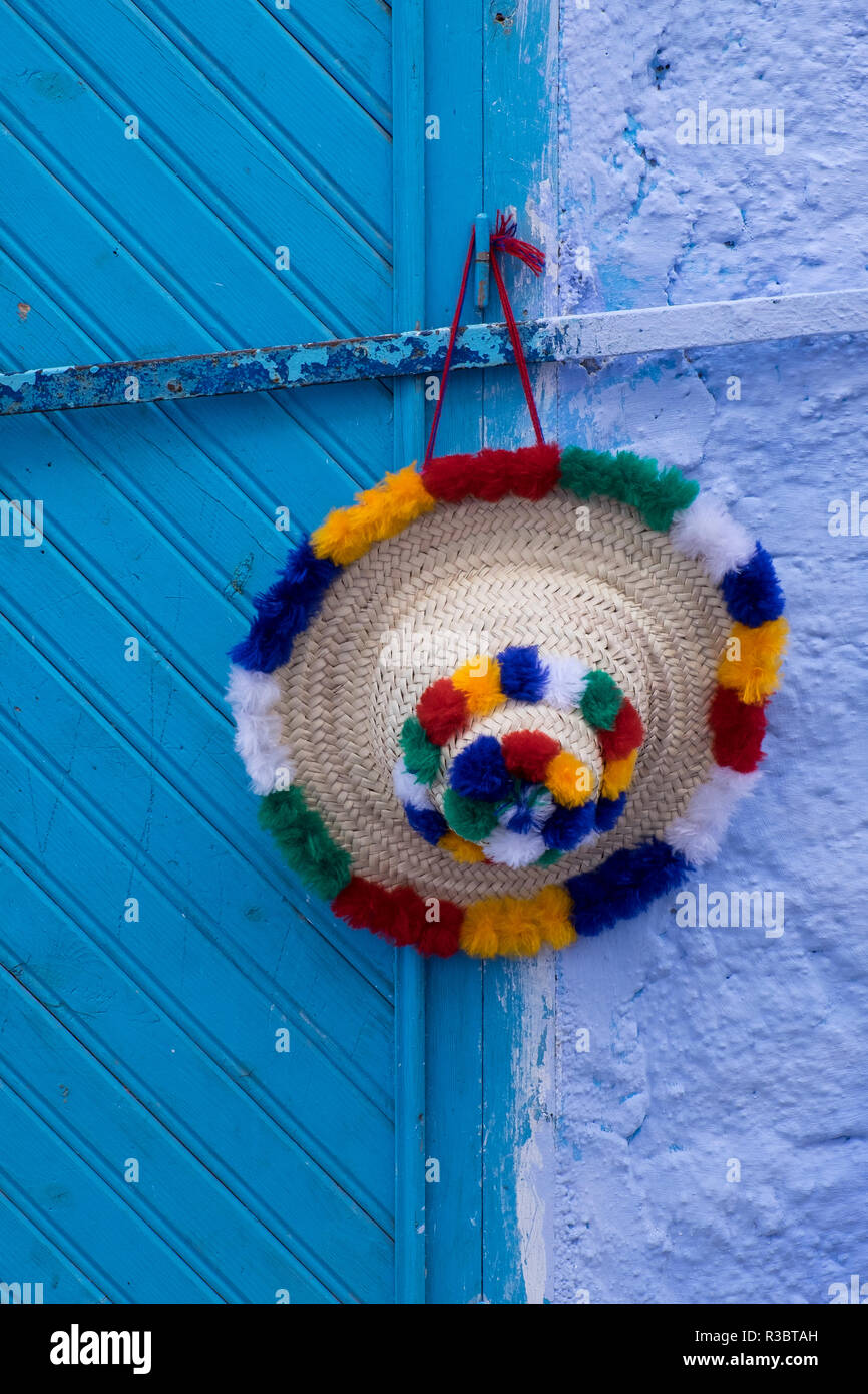 Africa, Morocco, Chefchaouen. A traditional woman's hat in the Rif mountain  area hangs on a blue door in the town of Chefchaouen Stock Photo - Alamy