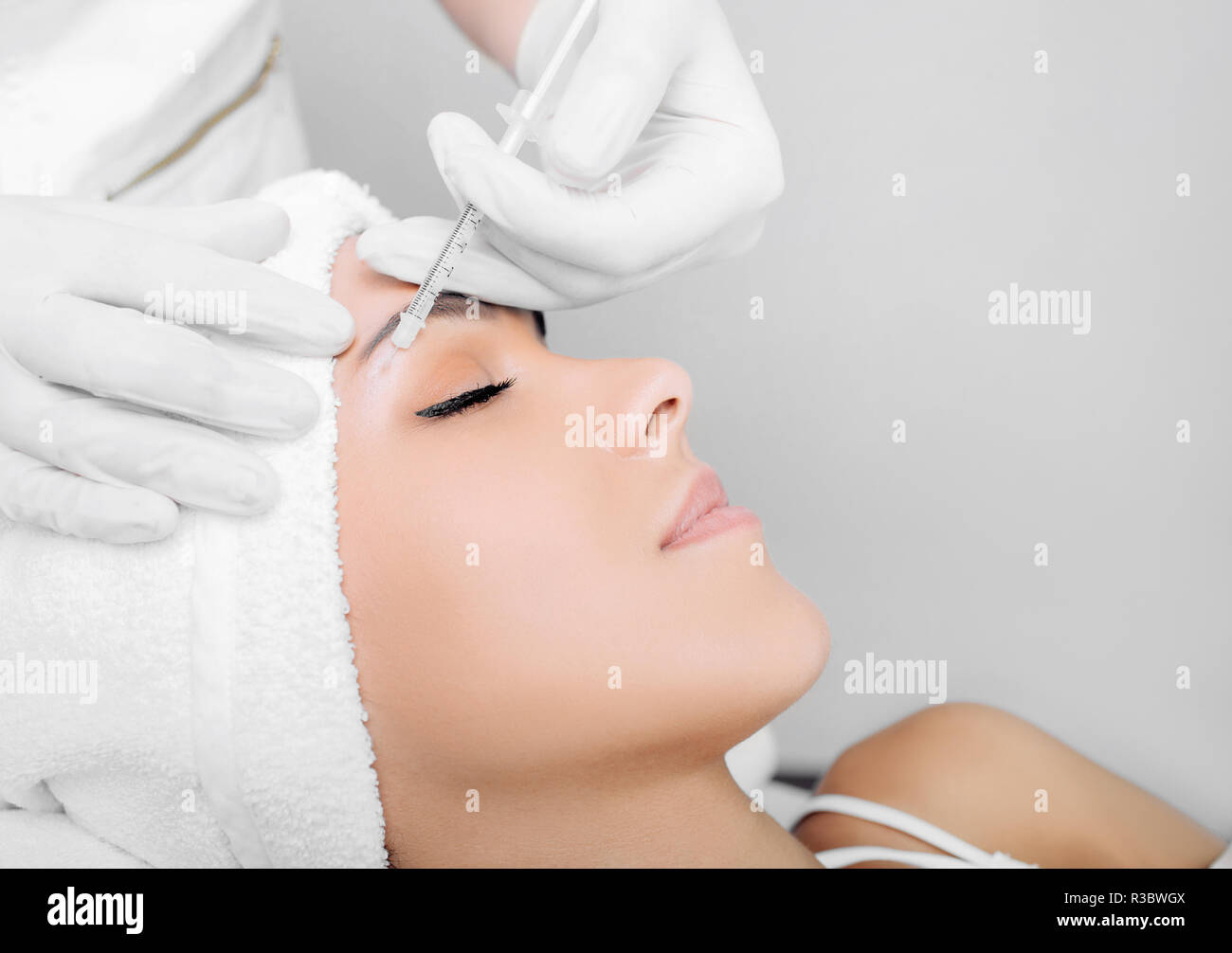 Close up of woman receiving beauty injection under eye, mesotherapy Stock Photo