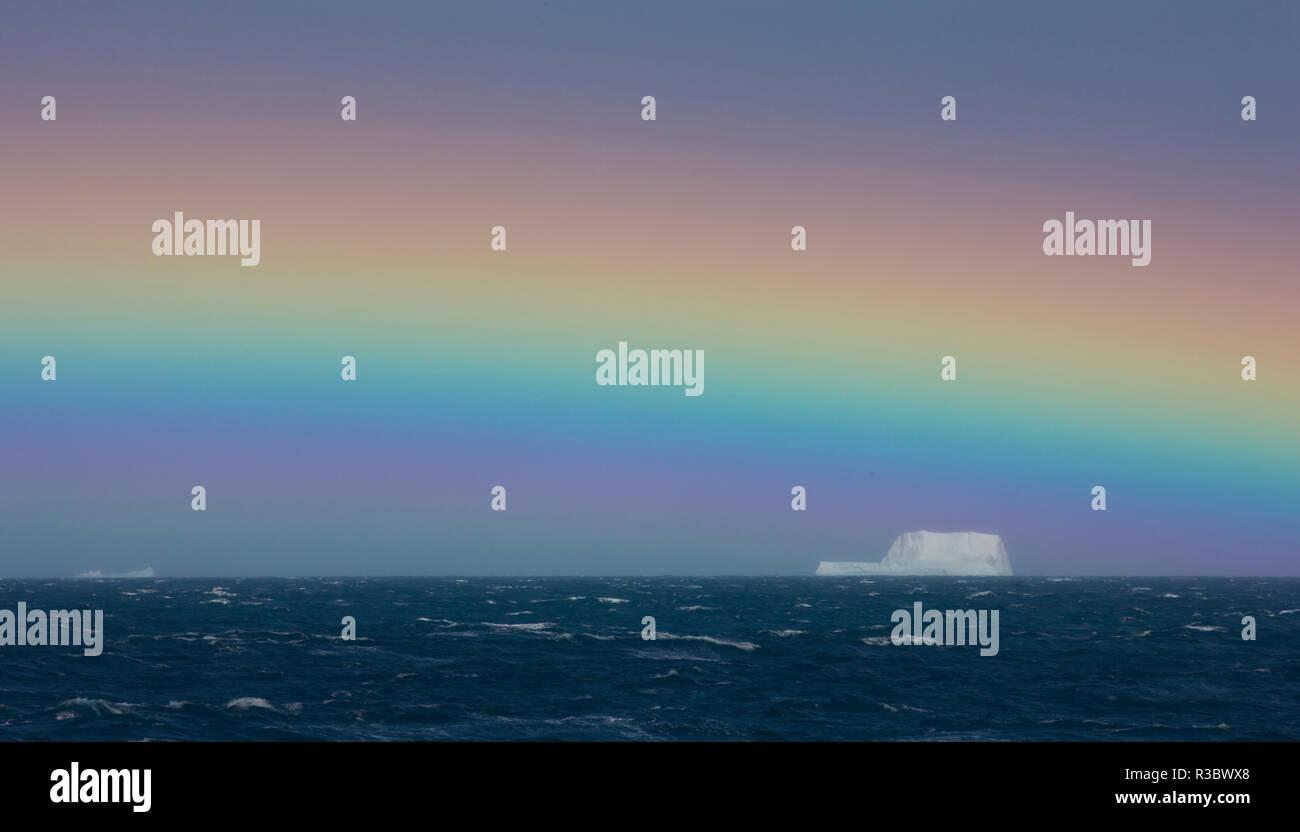 Rainbow over iceberg, South Georgia in the South Atlantic Ocean Stock Photo