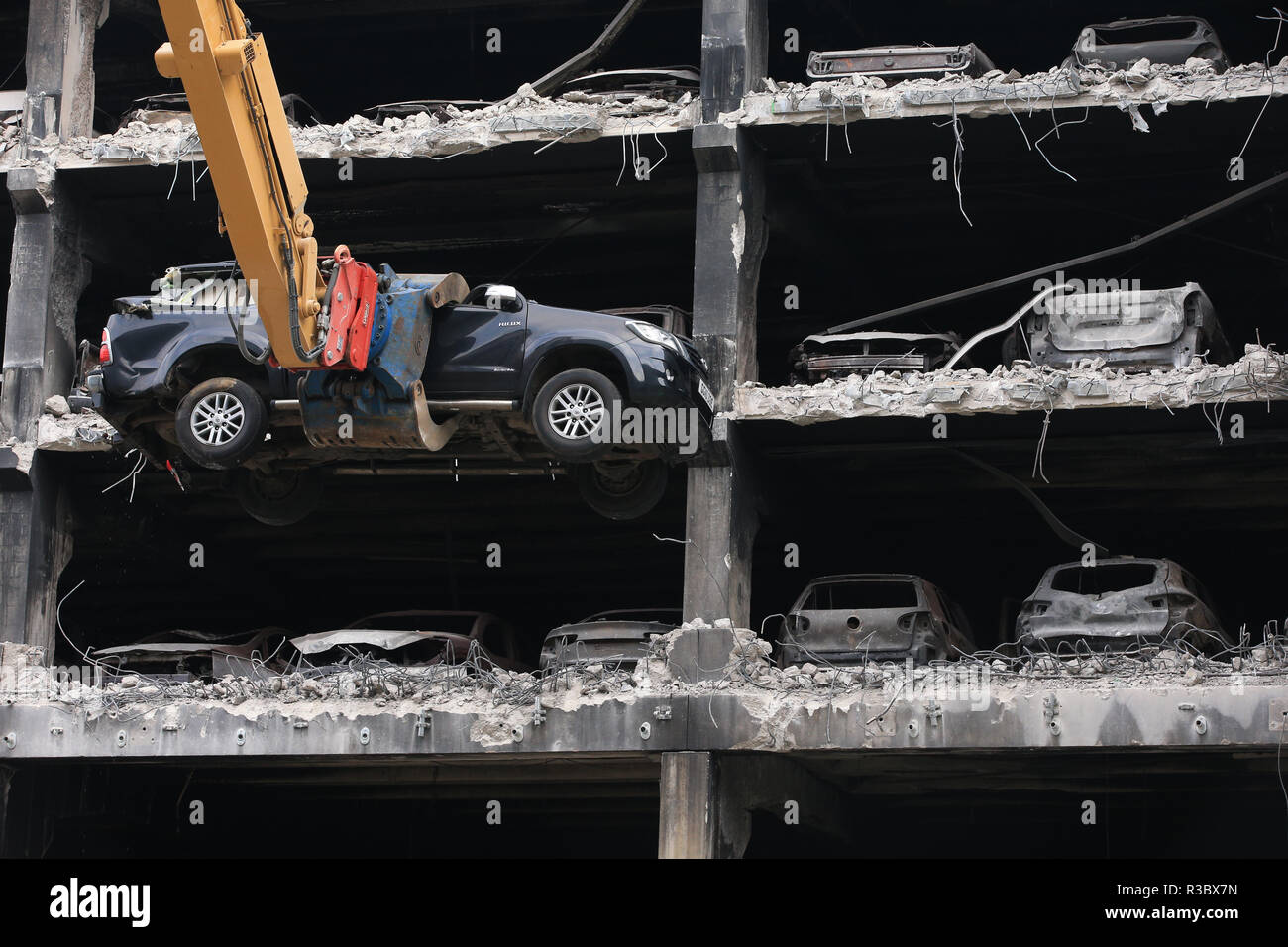 Burnt out cars and others that look undamaged but were written off by insurance companies due to fire and water damage are removed from their parking spaces as work began on Wednesday to demolish the multi-storey Liverpool Waterfront Car Park near to the Echo Arena which was destroyed by fire on New Year's Eve 2017. Stock Photo
