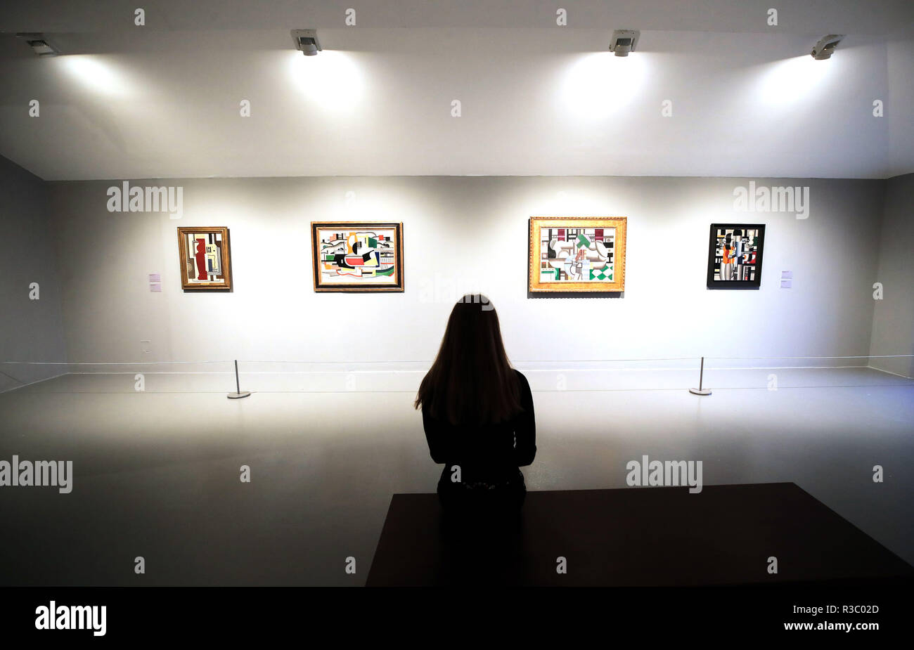 A gallery assistant look at the new exhibition by French Cubist Artist Fernand Leger: New Times New Pleasures, at Tate Liverpool. Stock Photo