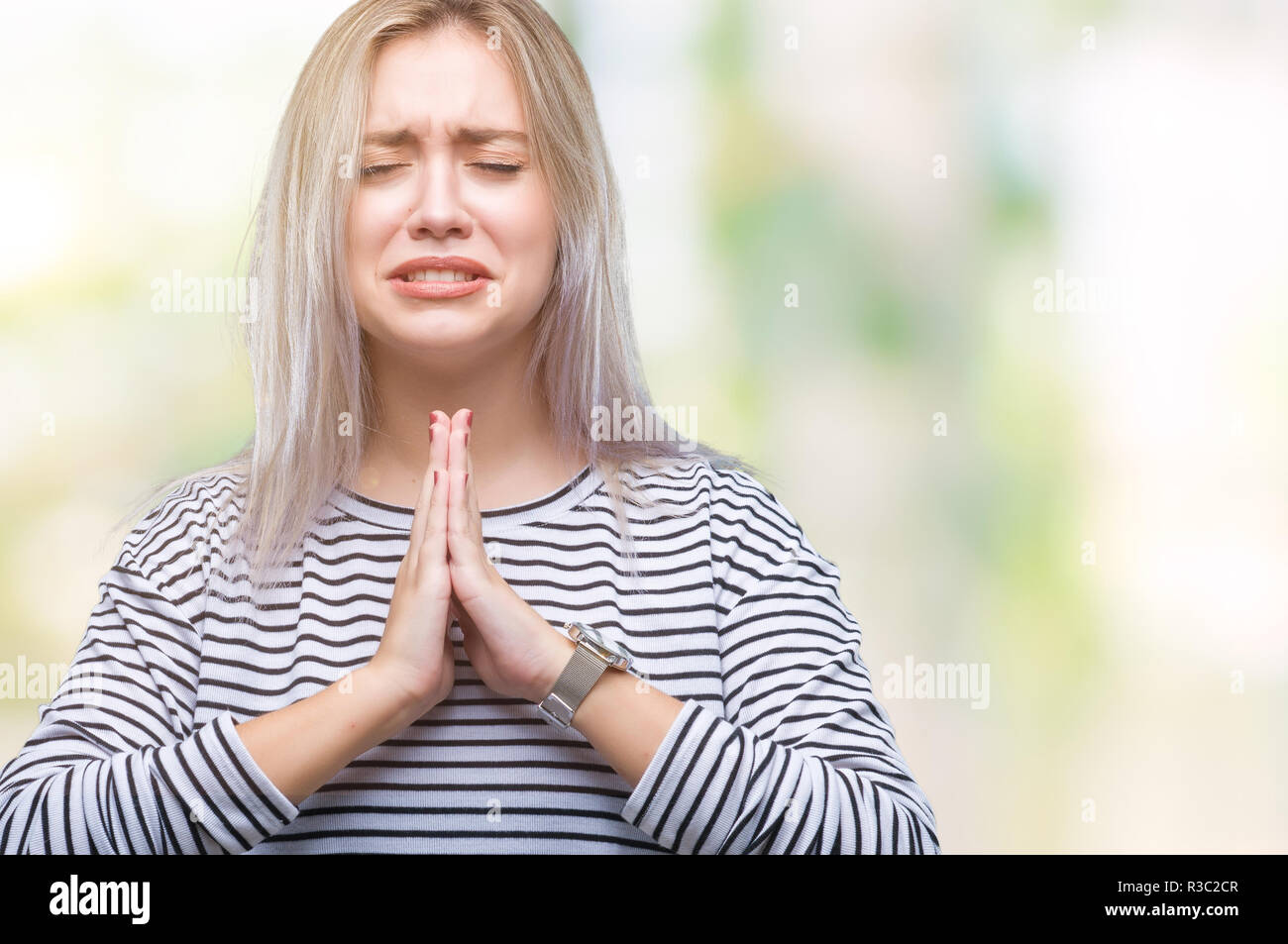 Young blonde woman over isolated background begging and praying with ...