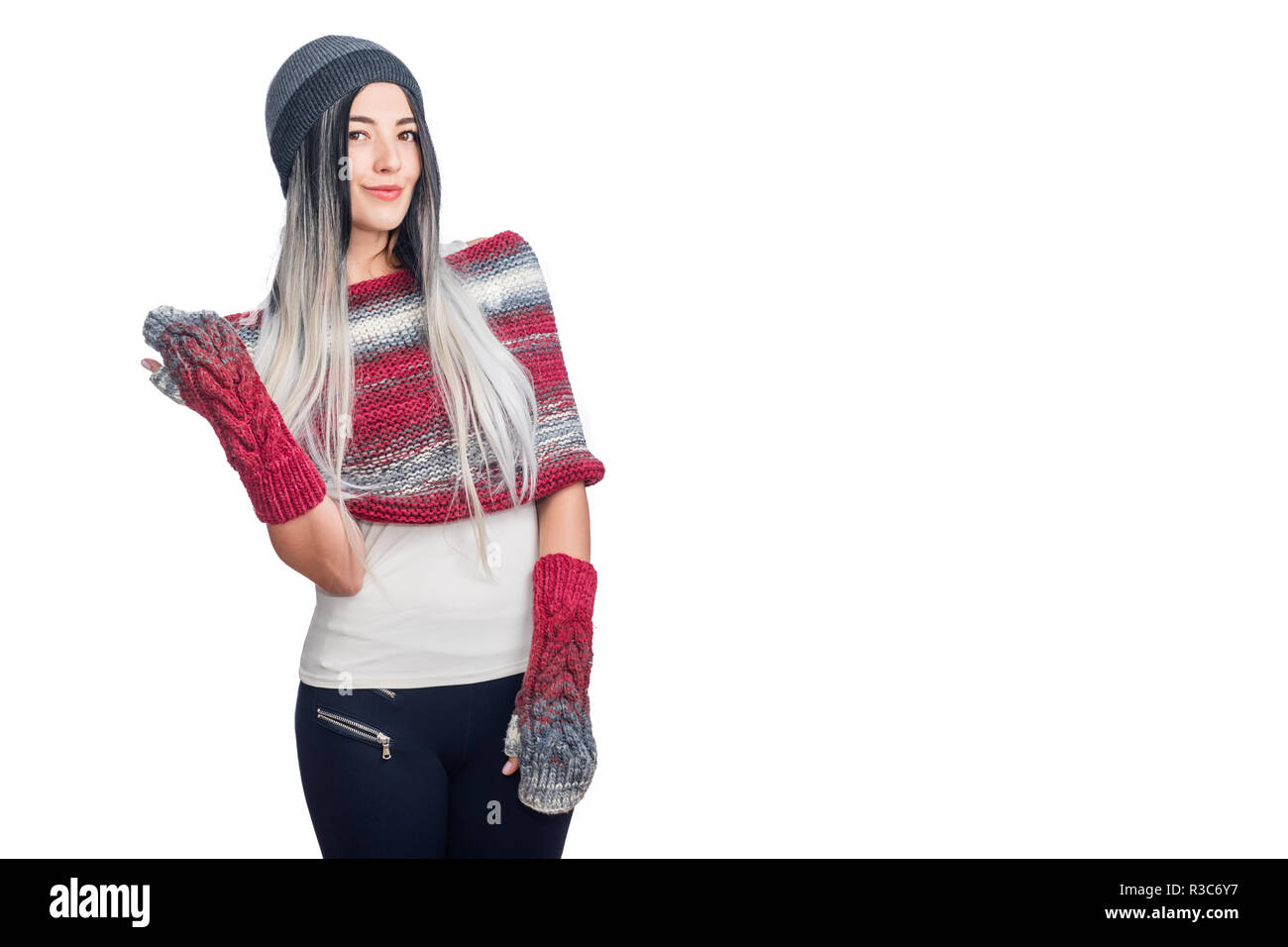 Beautiful cool girl wearing colored ombre hair extensions gesturing in hat and knitted clothes. Portrait of trendy style clever excited cute lovely te Stock Photo