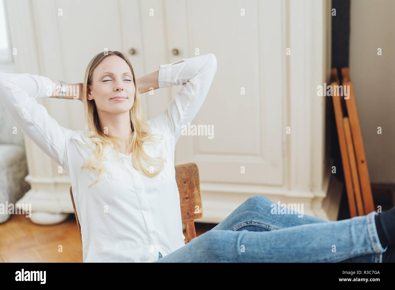 Woman sitting chair eyes closed hi-res stock photography and images - Alamy