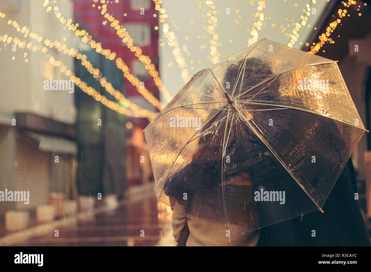 Couple in love on the street on a rainy day. Friends walking down the street Stock Photo