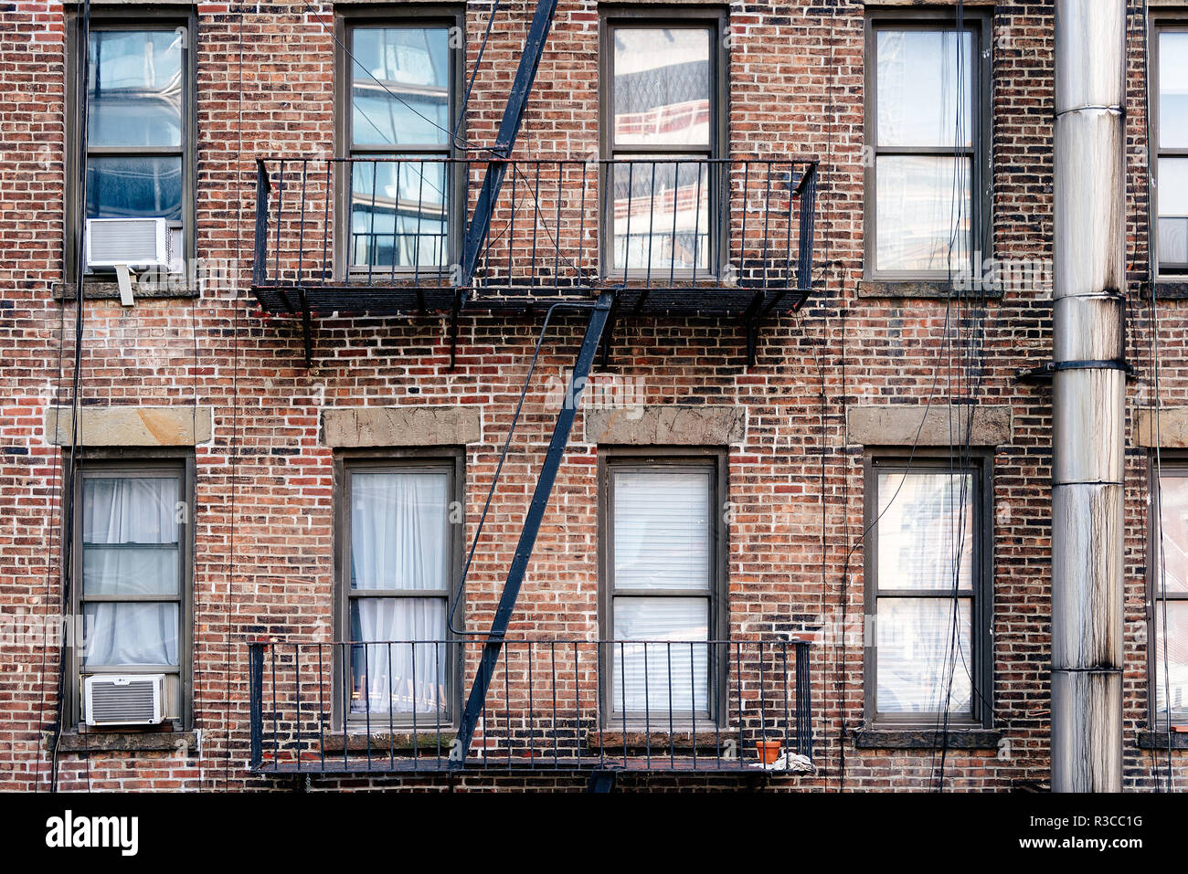 Old brick building with balconies and fire escape in Chelsea District