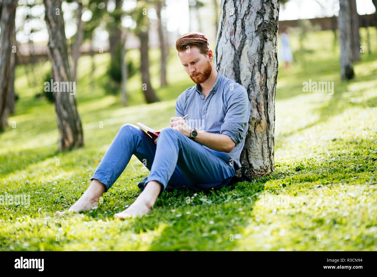 College student studying in park Stock Photo - Alamy