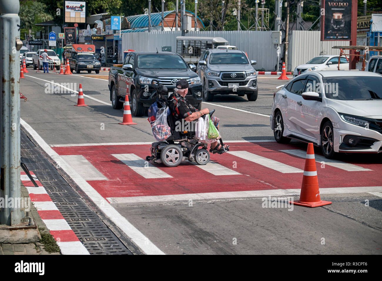 Man in wheelchair crossing road hires stock photography and images Alamy
