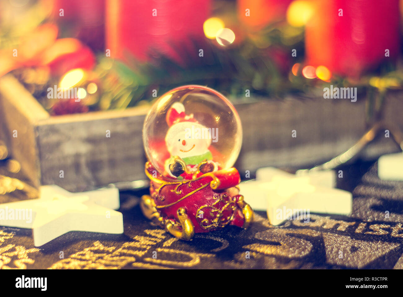 santa on table in snow globe Stock Photo