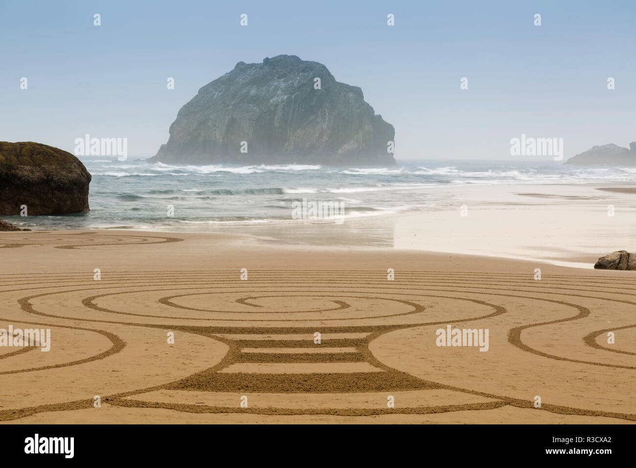 USA, Oregon, Bandon Beach. Free-hand sand design drawn at low tide by local artist. Stock Photo