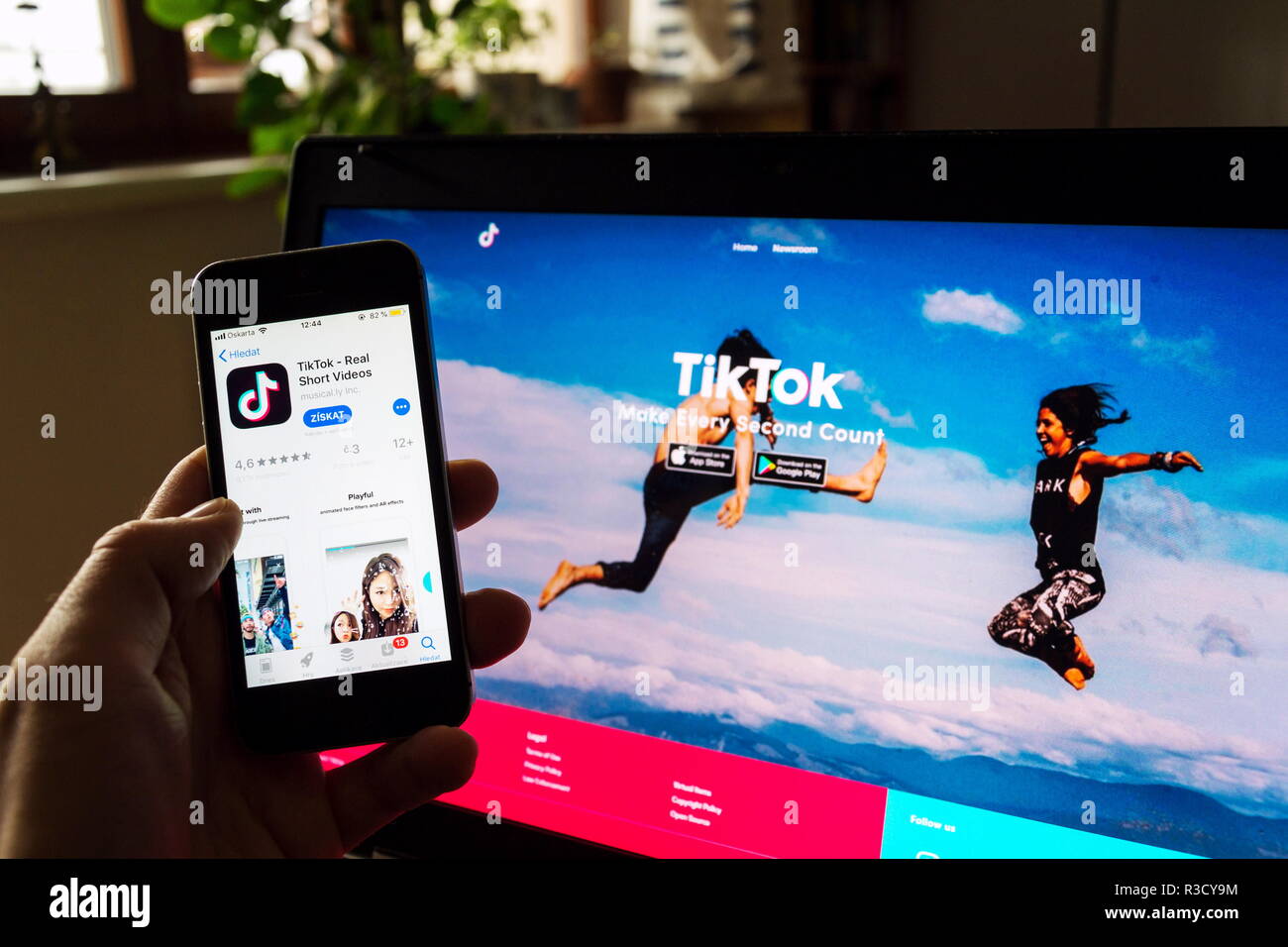 PRAGUE, CZECH REPUBLIC - NOVEMBER 22 2018: TikTok mobile video-sharing app company logo on phone screen with internet homepage in background Stock Photo