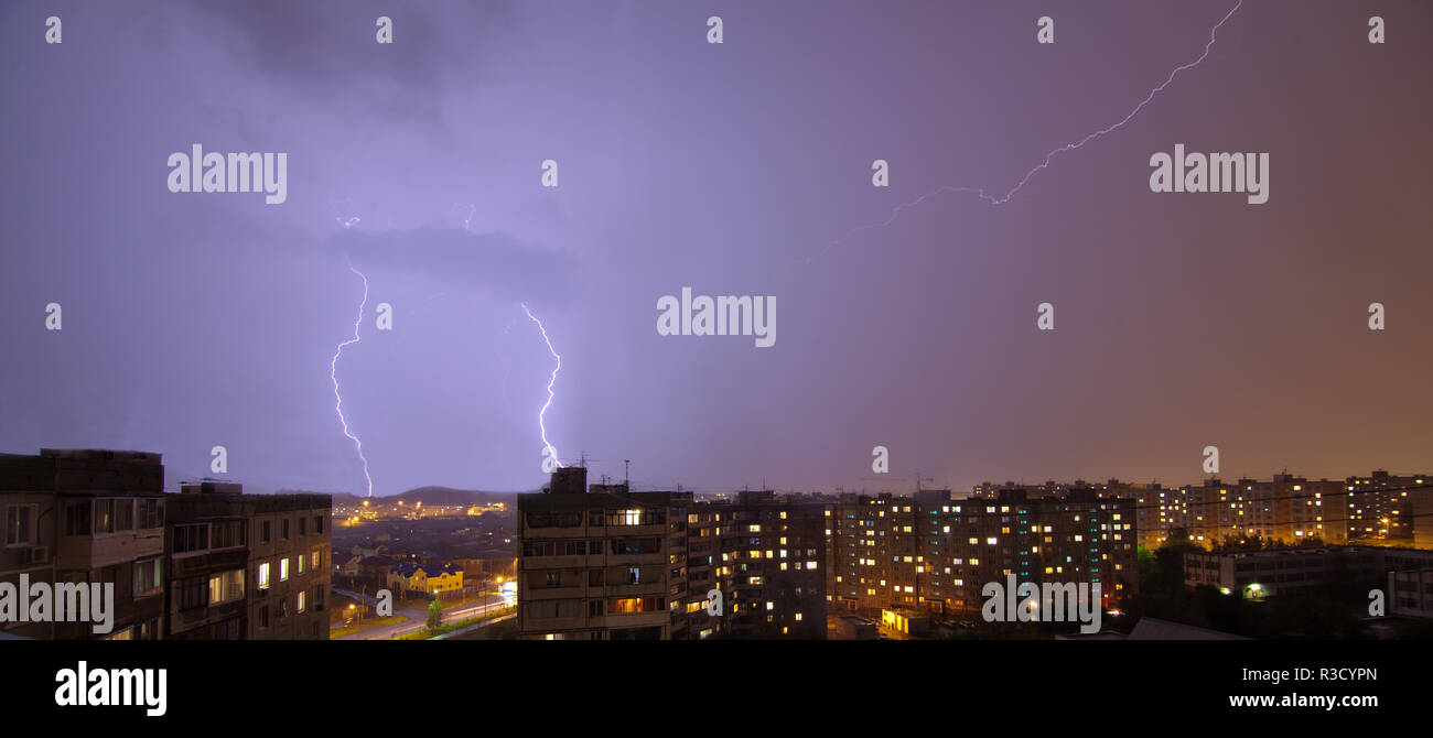 Lightning flashing over night rainy summer city Stock Photo - Alamy