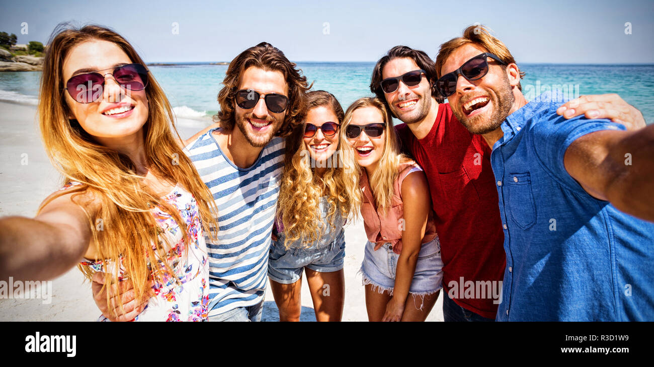 Cheerful friends at beach on sunny day Stock Photo