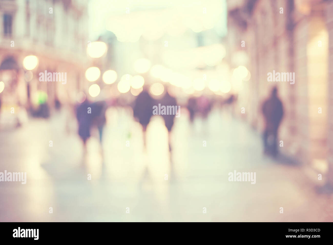 abstract blur people background, silhouettes of unrecognizable people walking on a street in winter evening with bokeh lights Stock Photo