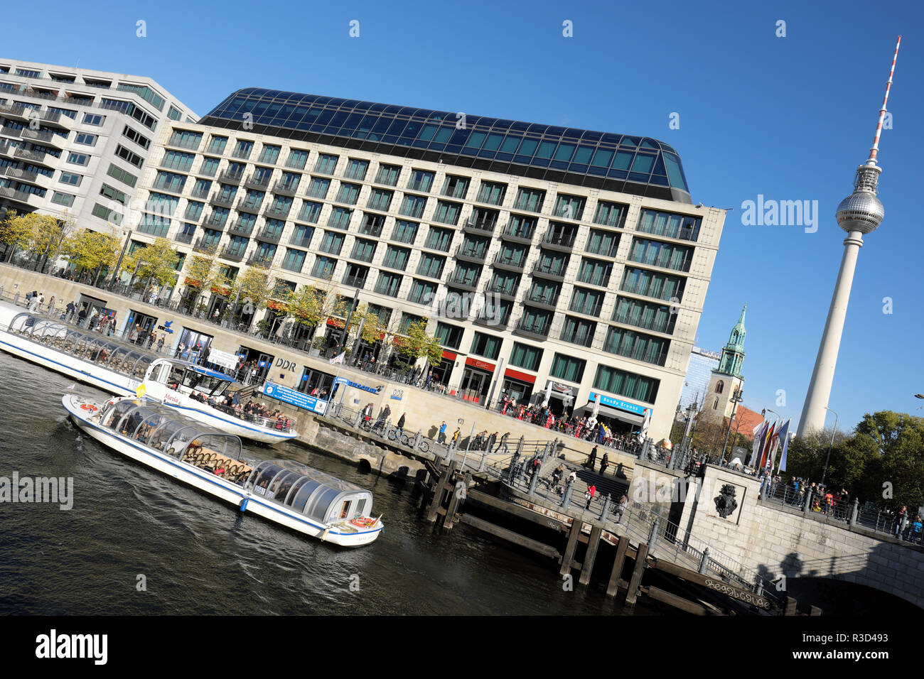 Berlin Germany - Boat tours on the River Spree pass the DDR Museum with the Fernsehturm TV Tower in background - Autumn 2018 Stock Photo