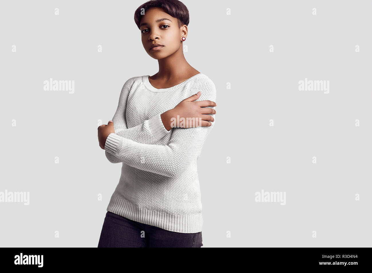 Portrait of young beautiful hipster black girl with short hair in white