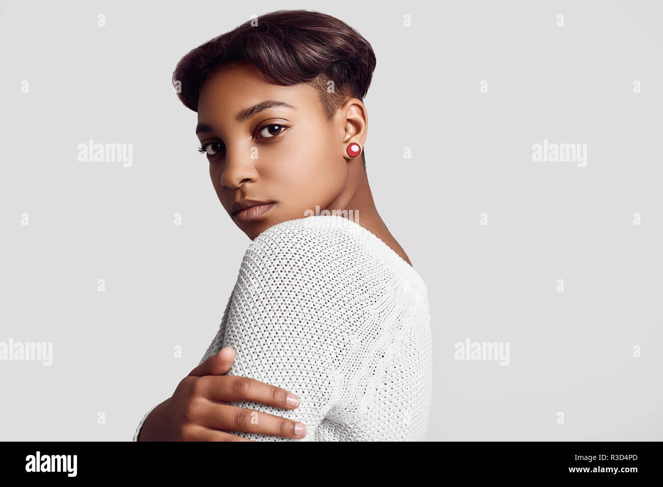 Close portrait of young beautiful hipster black girl with short hair in