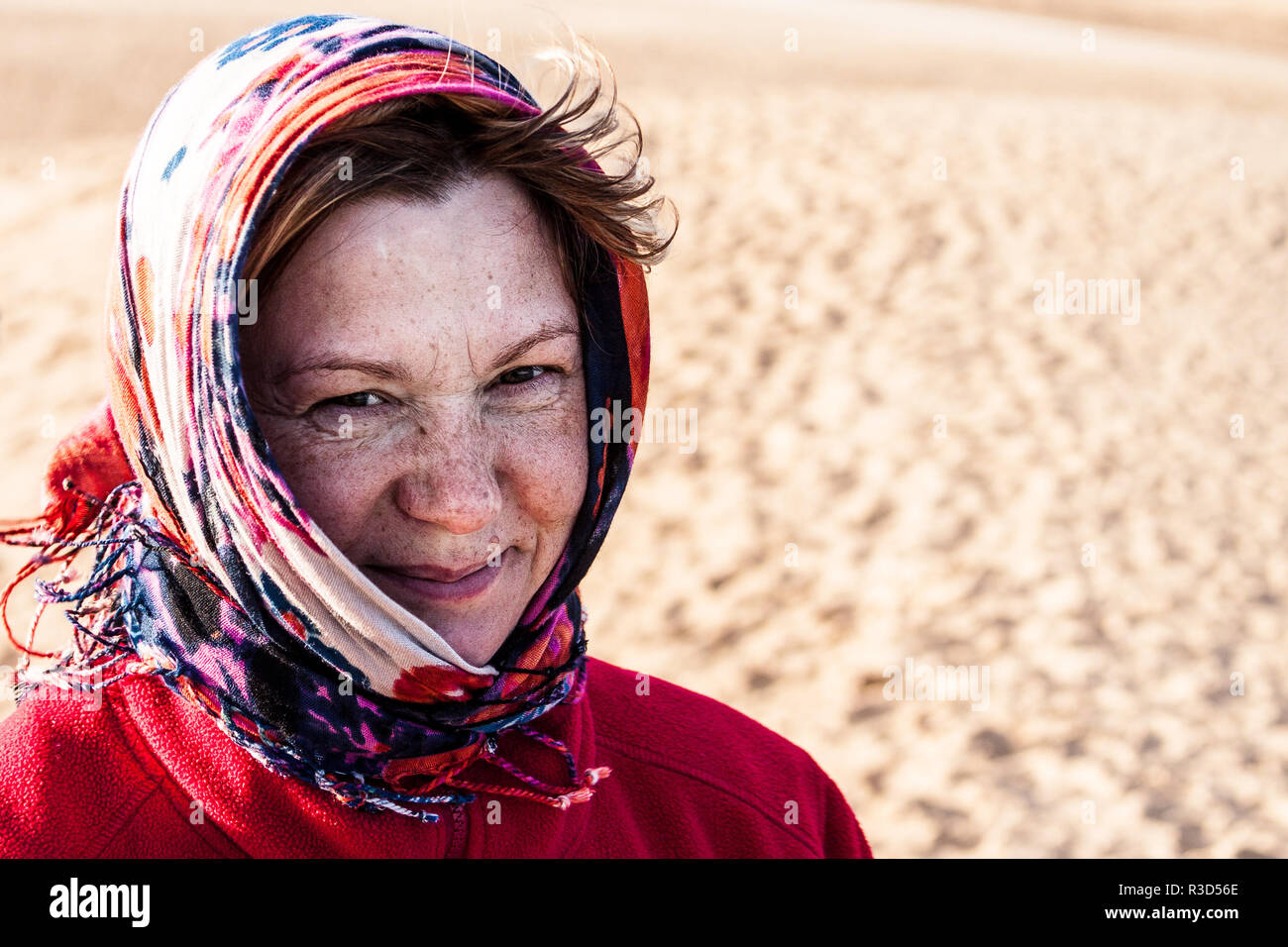 woman with head scarf in the wind Stock Photo