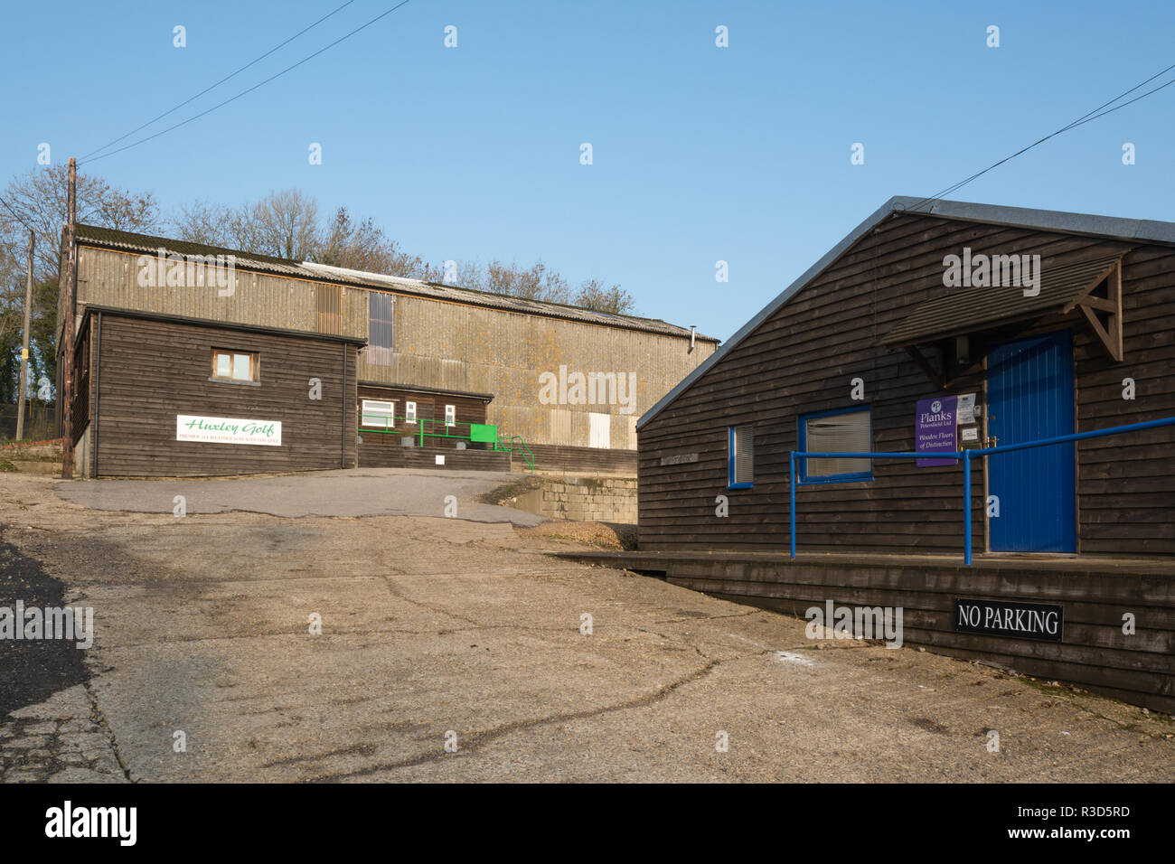 Small businesses in converted farm buildings in the village of Warnford in Hampshire, UK. Huxley Golf and Planks of Petersfield in the Long Barn Stock Photo