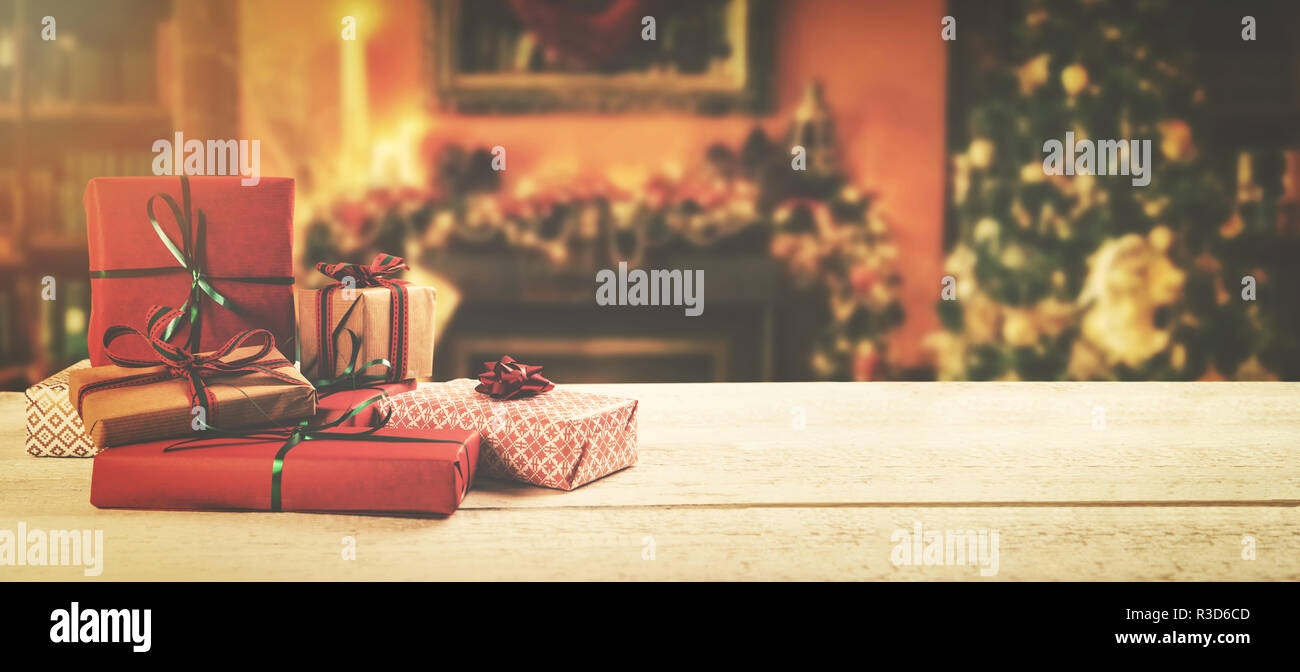 christmas background - wrapped gifts on the table in the decorated room with copy space Stock Photo