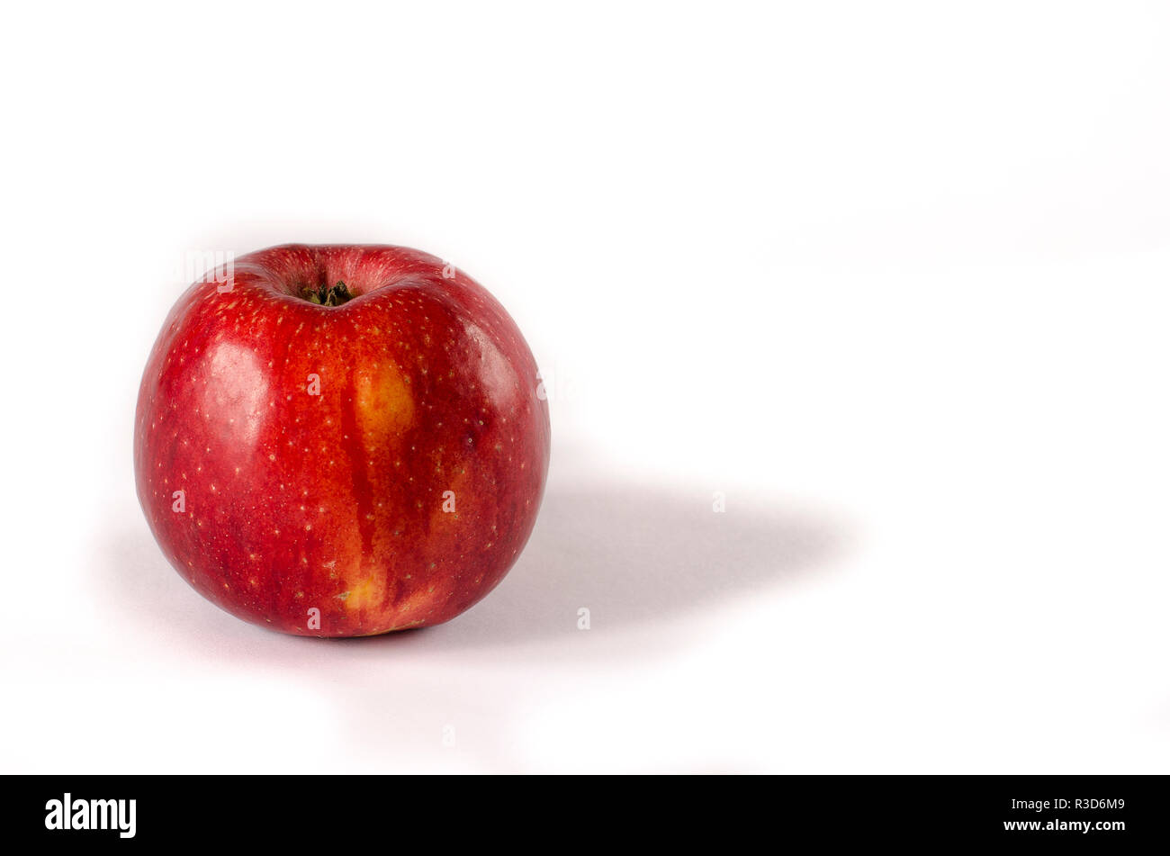 A red appetizing apple with a yellow side lies on a white isolated ...