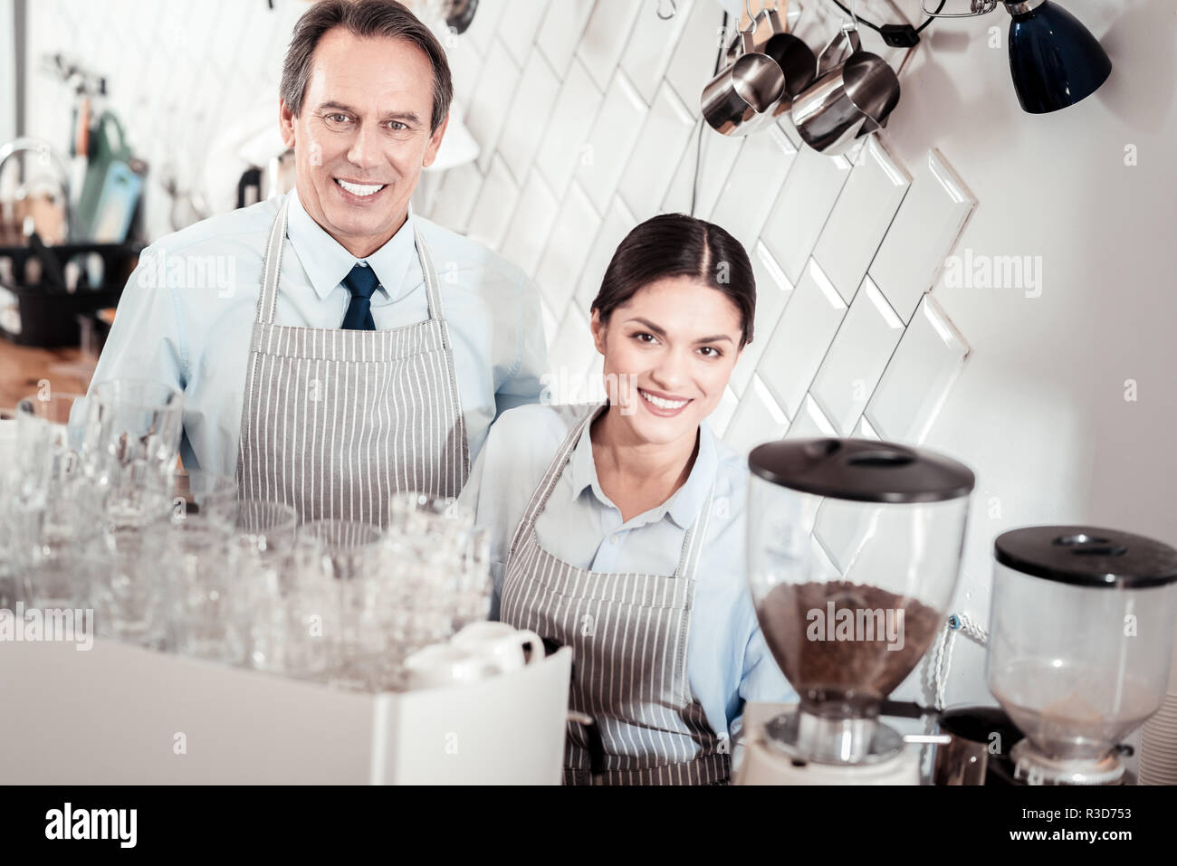 Our job. Joyful skilled baristas smiling to you while working in the