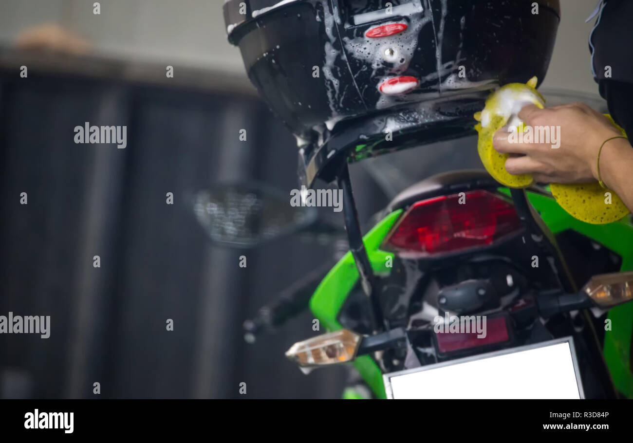 Motorcycle clean service. Employees are washing motorbikes Stock Photo