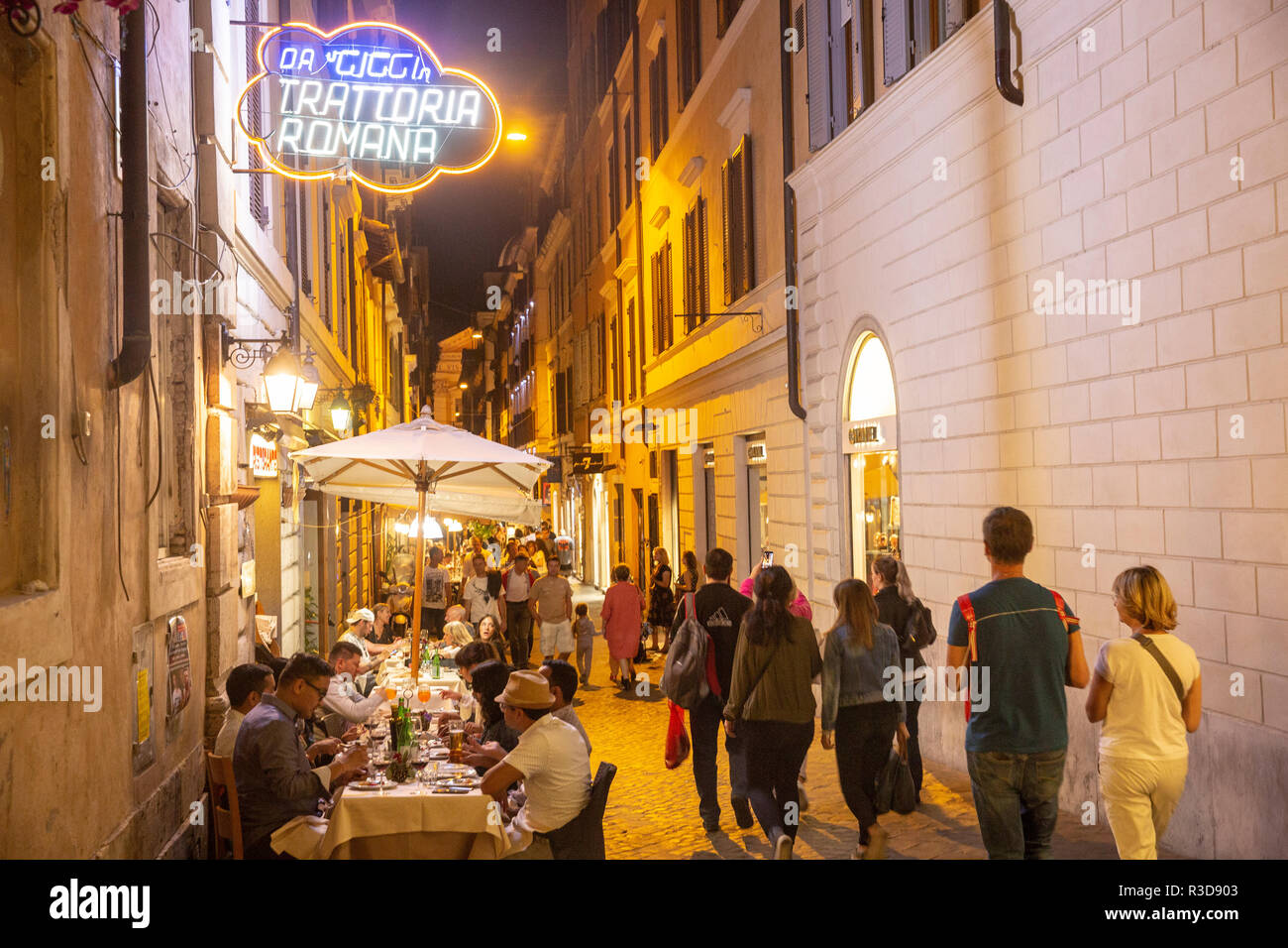 Street night scene in Rome city centre with people having dinner, Italy,Europe, people eating at an Italian Trattoria,2018 Stock Photo