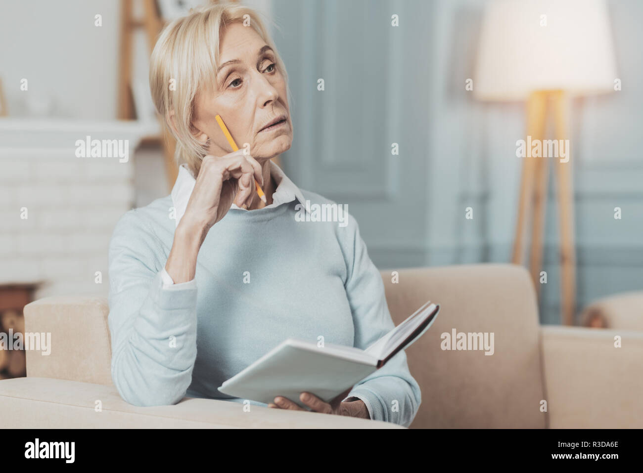 My work. Pleasant smart woman taking notes while working at home Stock Photo