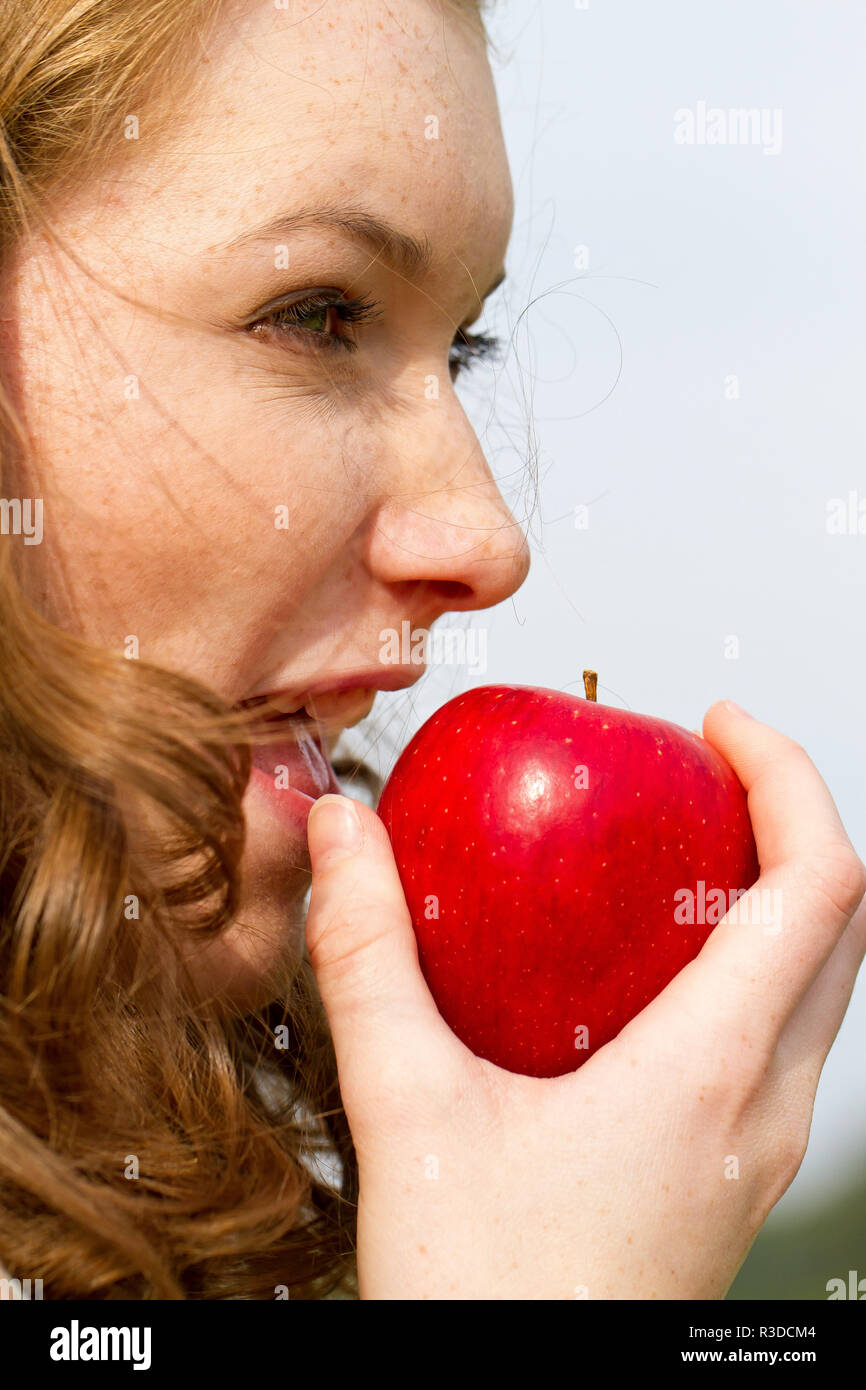 young woman eating the apple Stock Photo