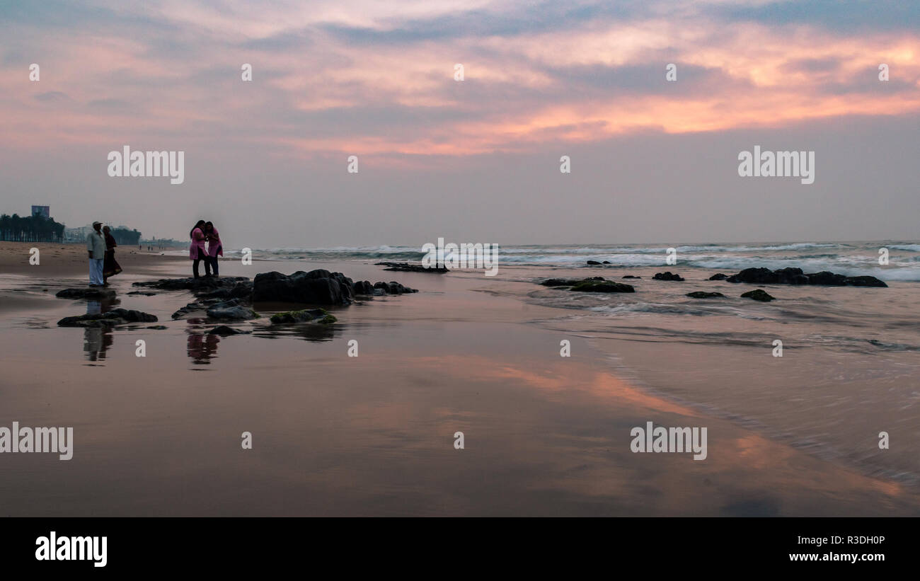 November 12,2018. Visakhapatnam, India. Tourists enjoying sunrise at Ramakrishna Beach. Stock Photo