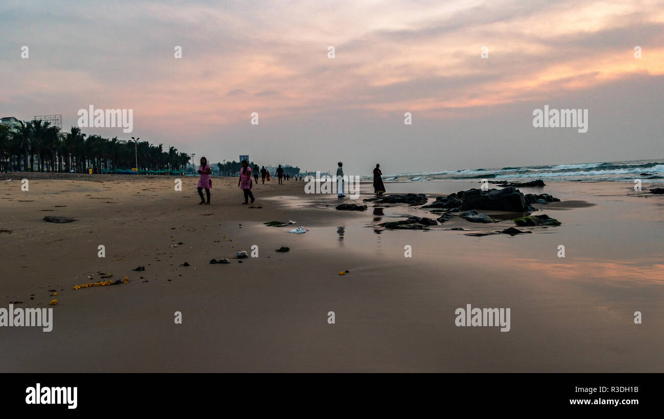 November 12,2018. Visakhapatnam, India. Tourists enjoying sunrise at Ramakrishna Beach. Stock Photo