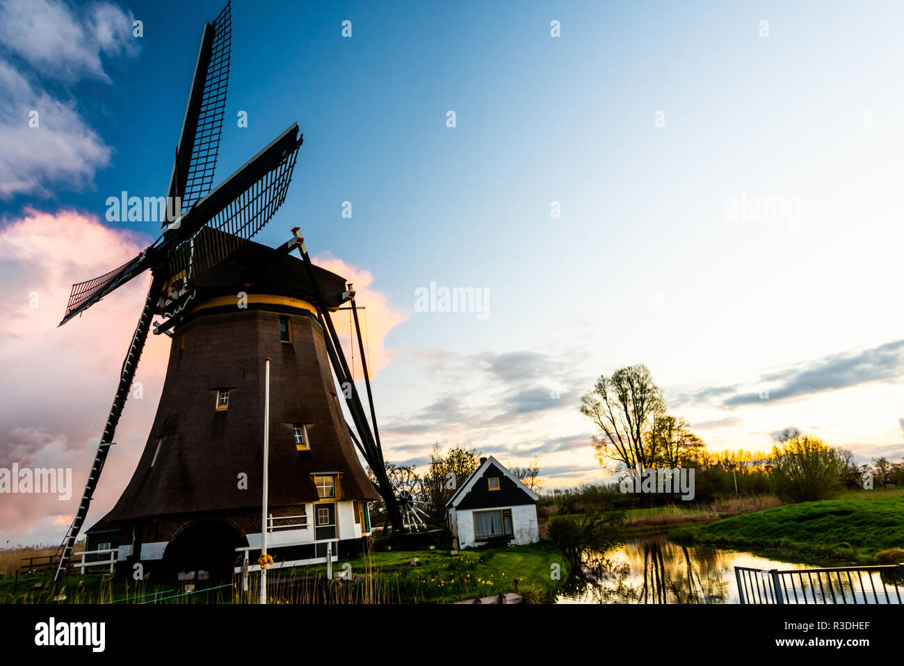 Dutch windmill during sunrise in the Netherlands Stock Photo - Alamy