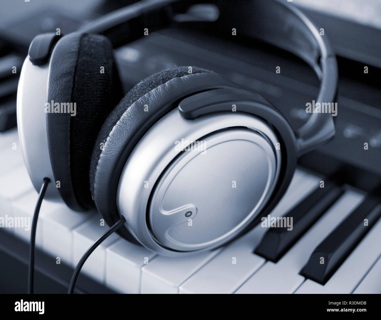 headphones on a keyboard Stock Photo Alamy
