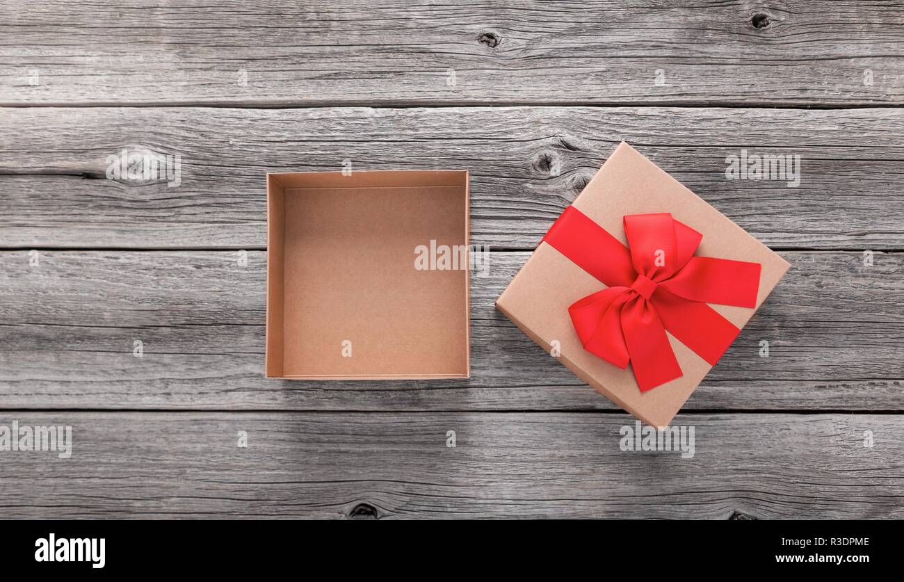 Open gift box on the background of wooden boards. Stock Photo