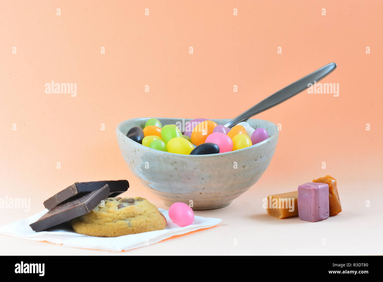 A close-up photo of a meal consisting of some colorful jelly beans, mixed sweets and cookies. Concept of unhealthy diet Stock Photo