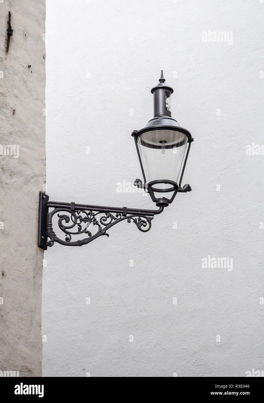 Elegant and simple black corner wall lantern mounted against a white wall in Lucerne, Switzerland. Stock Photo
