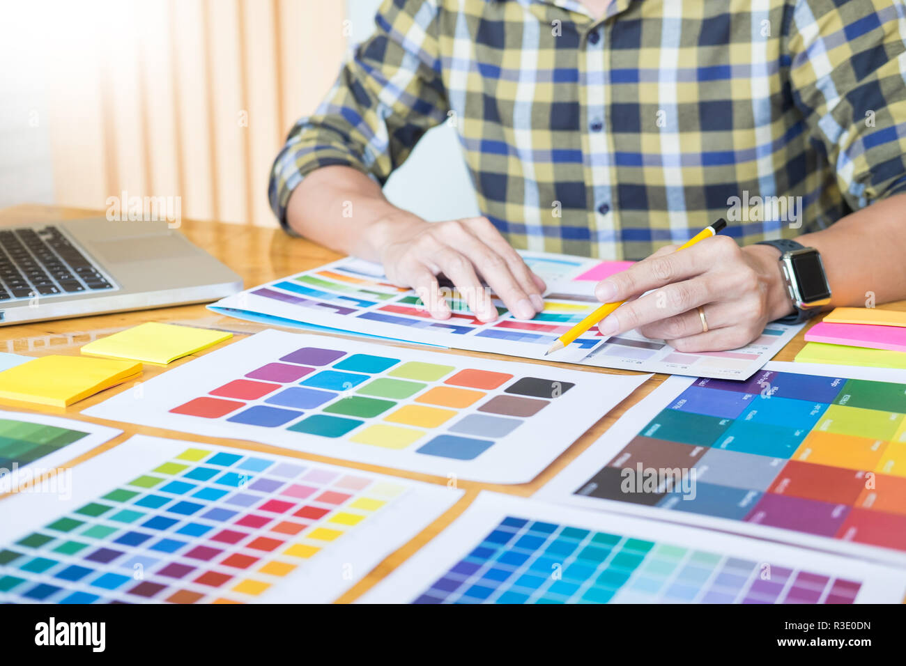 Creative Graphic designer at work. Color swatch samples pantone palette