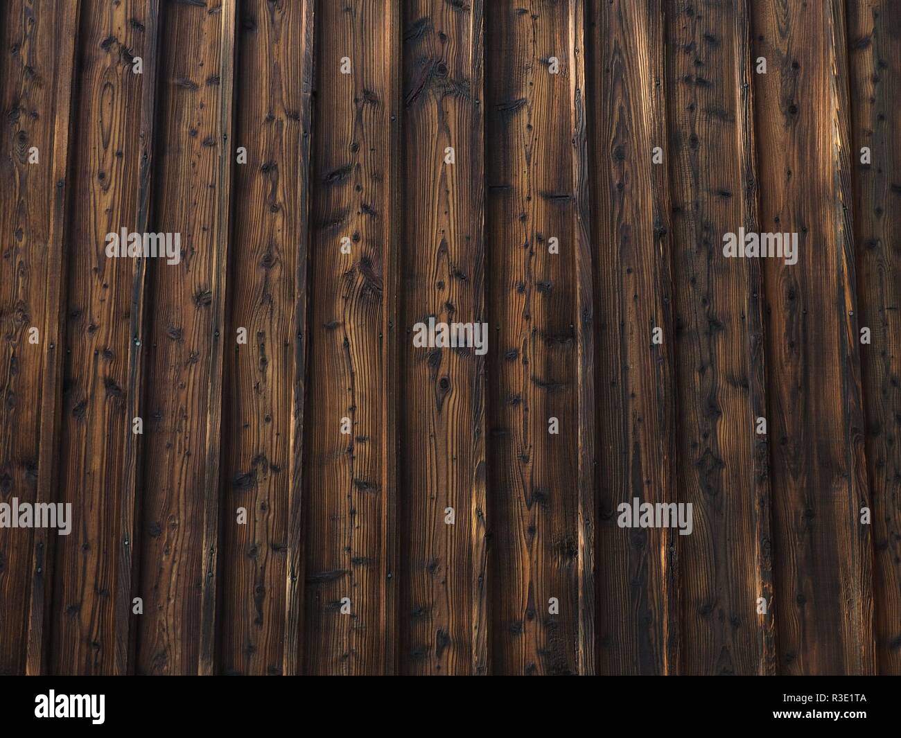 An old wooden building wall with a lot of knots Stock Photo