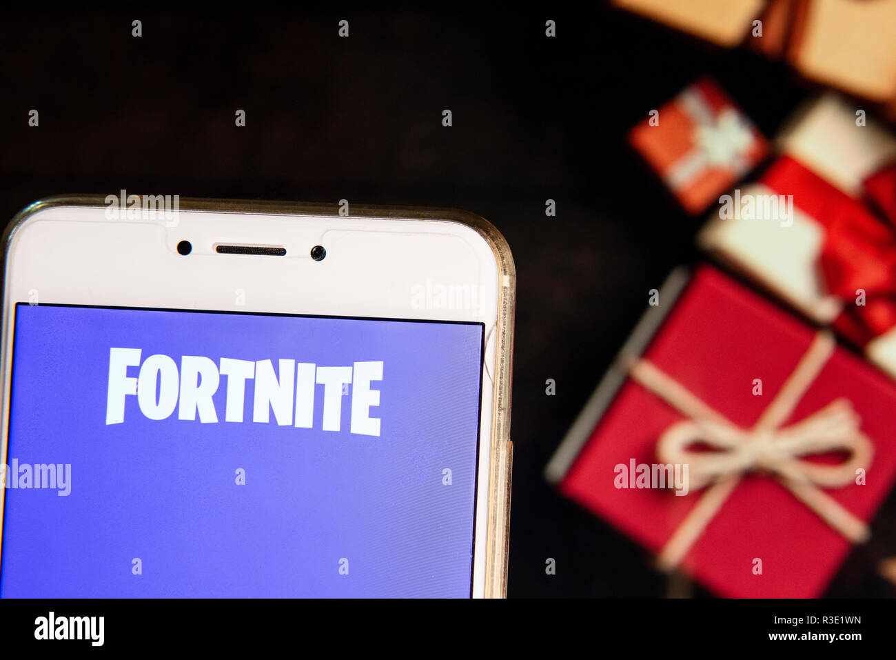 Online Video Game By Epic Games Company Fortnite Logo Is Seen On An Android Mobile Device With A Christmas Wrapped Gifts In The Background Stock Photo Alamy