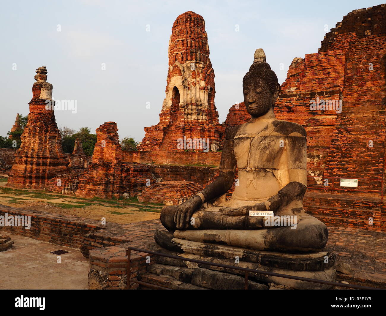 Seated Buddha and Wat Mahathat temple in Ayutthaya Stock Photo