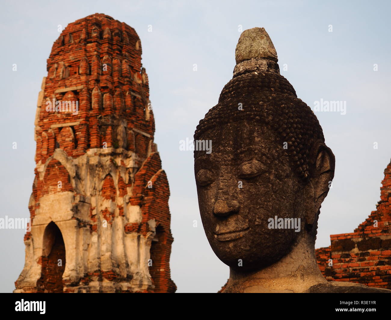 Buddha head and red brick pagoda Stock Photo