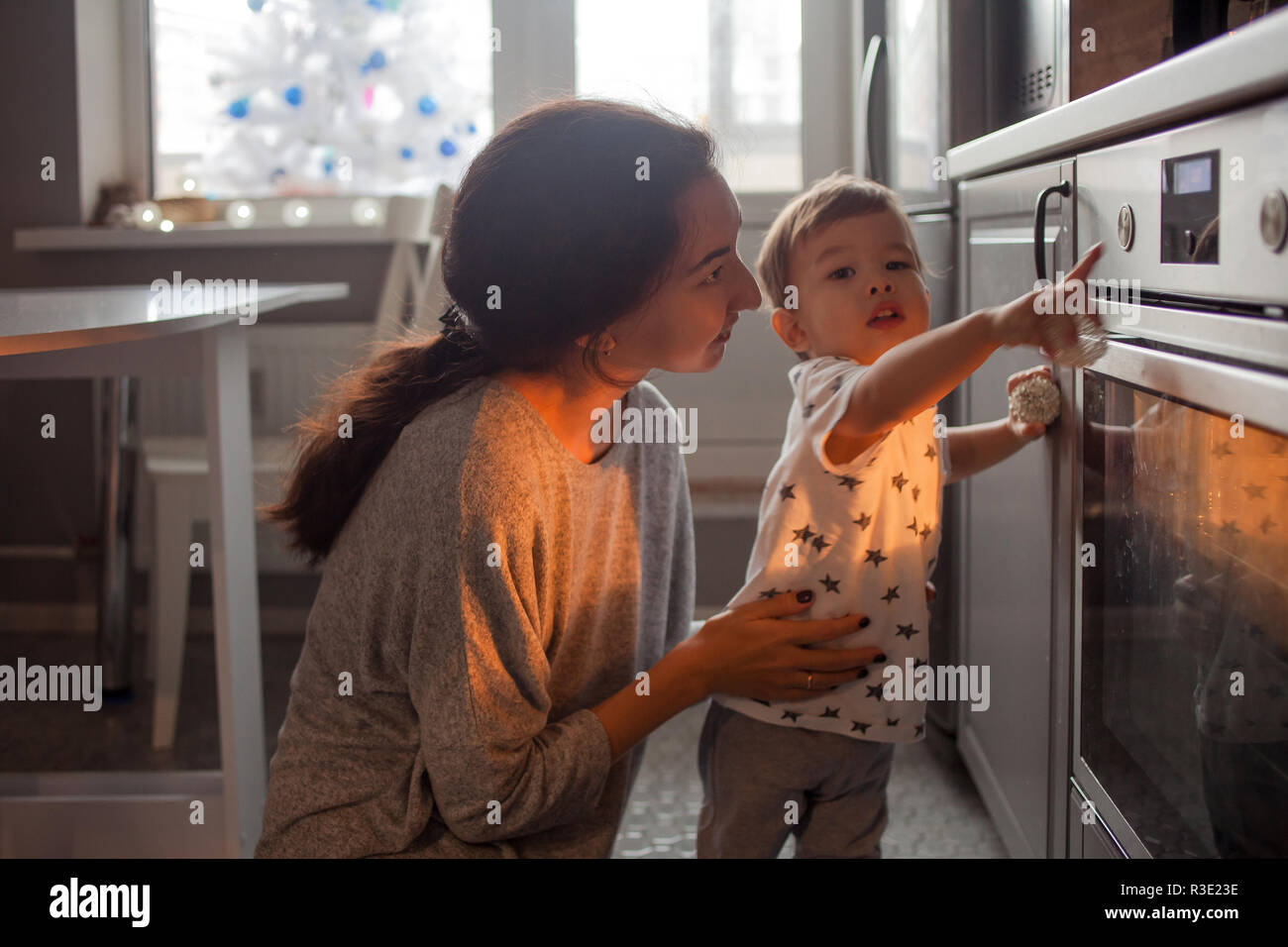 Young Multiethnic Family Making A Cake Together Mom Dad And Son Pull The Cake Out Of The Oven Stock Photo Alamy