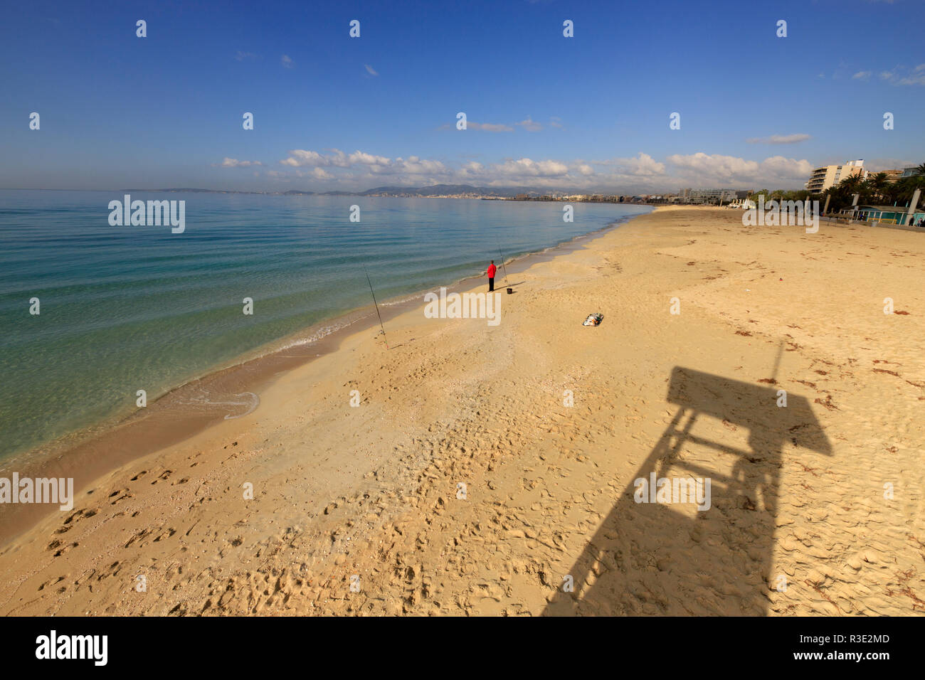Mallorca beach, PLaya de Palma, winter time, man fishing on shoreline Stock Photo