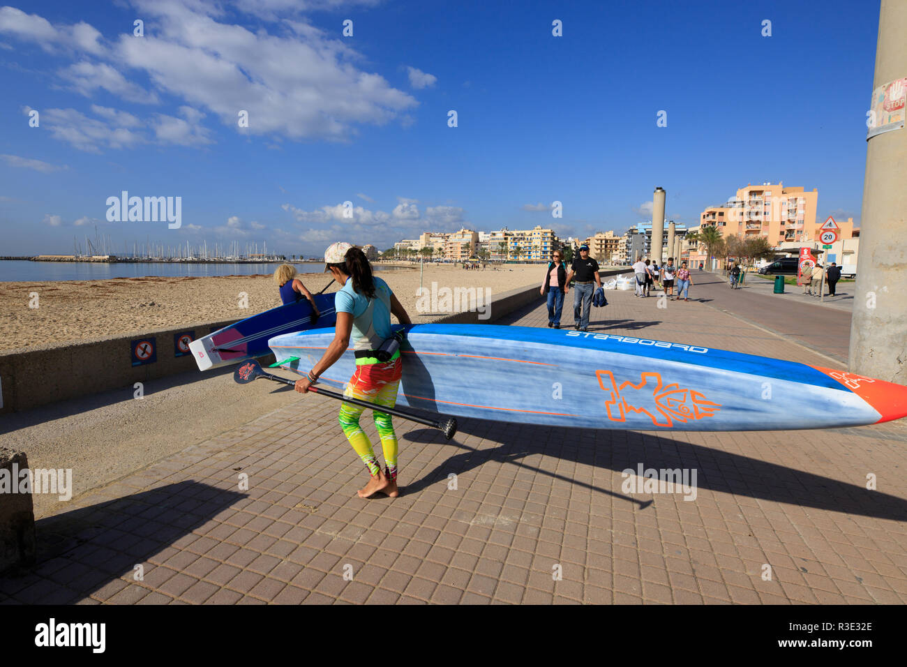 women preparing to surf with padel table, Mallorca beach, PLaya de Palma, winter time Stock Photo