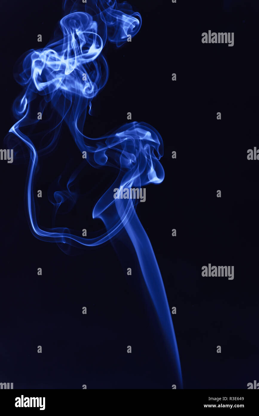Blue smoke on a black background Stock Photo - Alamy