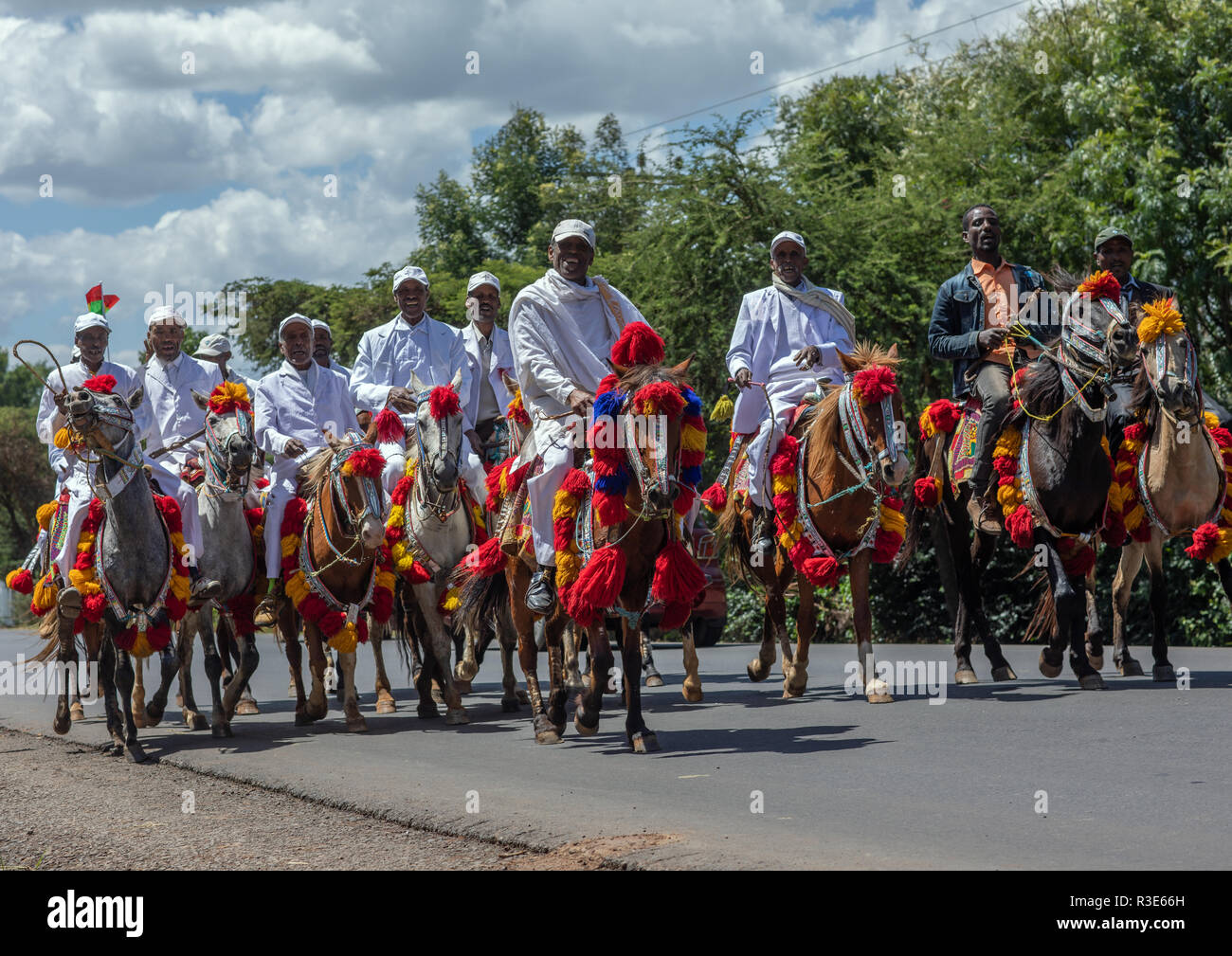 Ethiopian men riding horses on a road during an oromo liberation front party celebration, Oromia, Waliso, Ethiopia Stock Photo